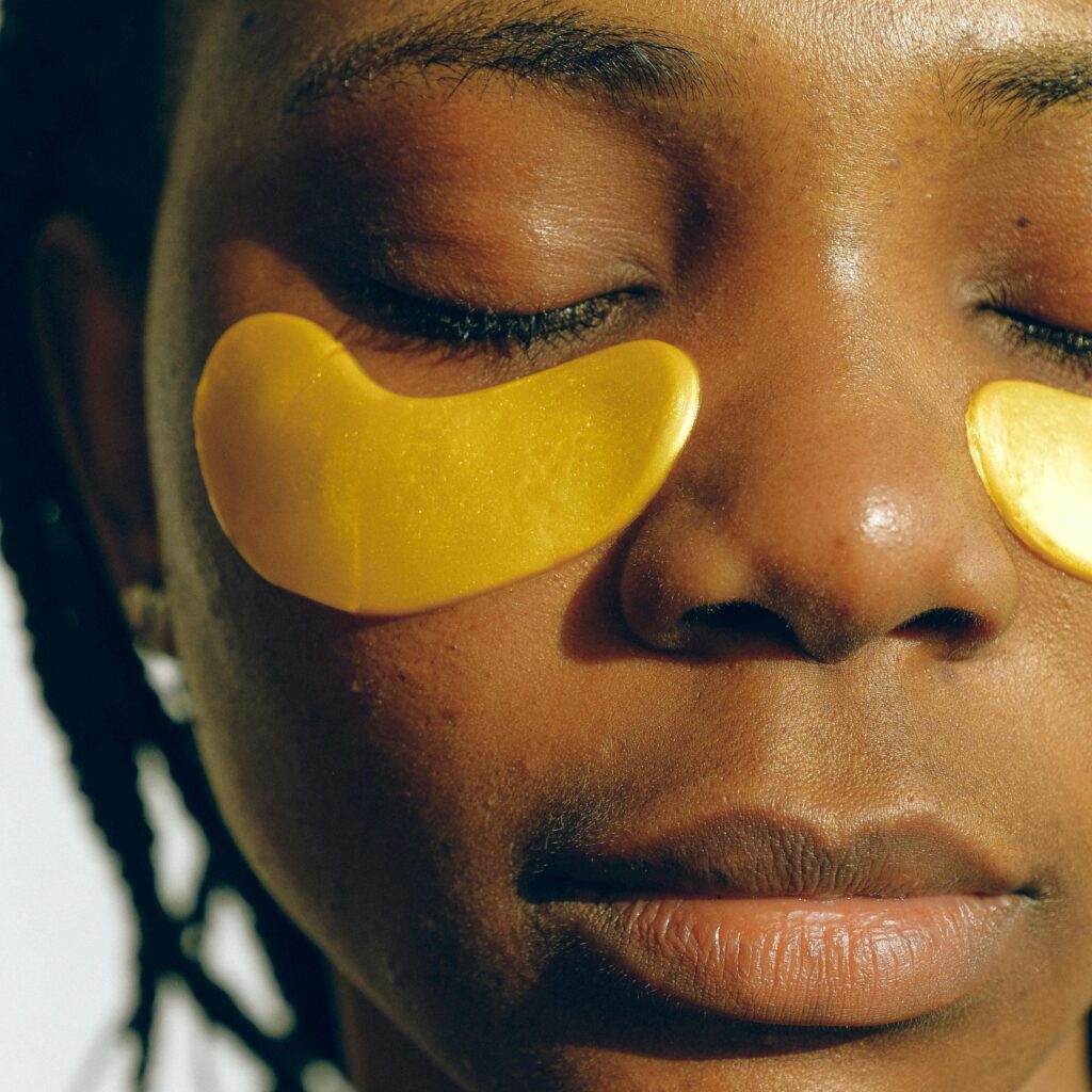 pexels-photo-3852204-3852204 Crop gentle African American female with closed eyes and clean face enjoying cosmetic procedure for smoothing and moisturizing skin under eyes and removing dark circles